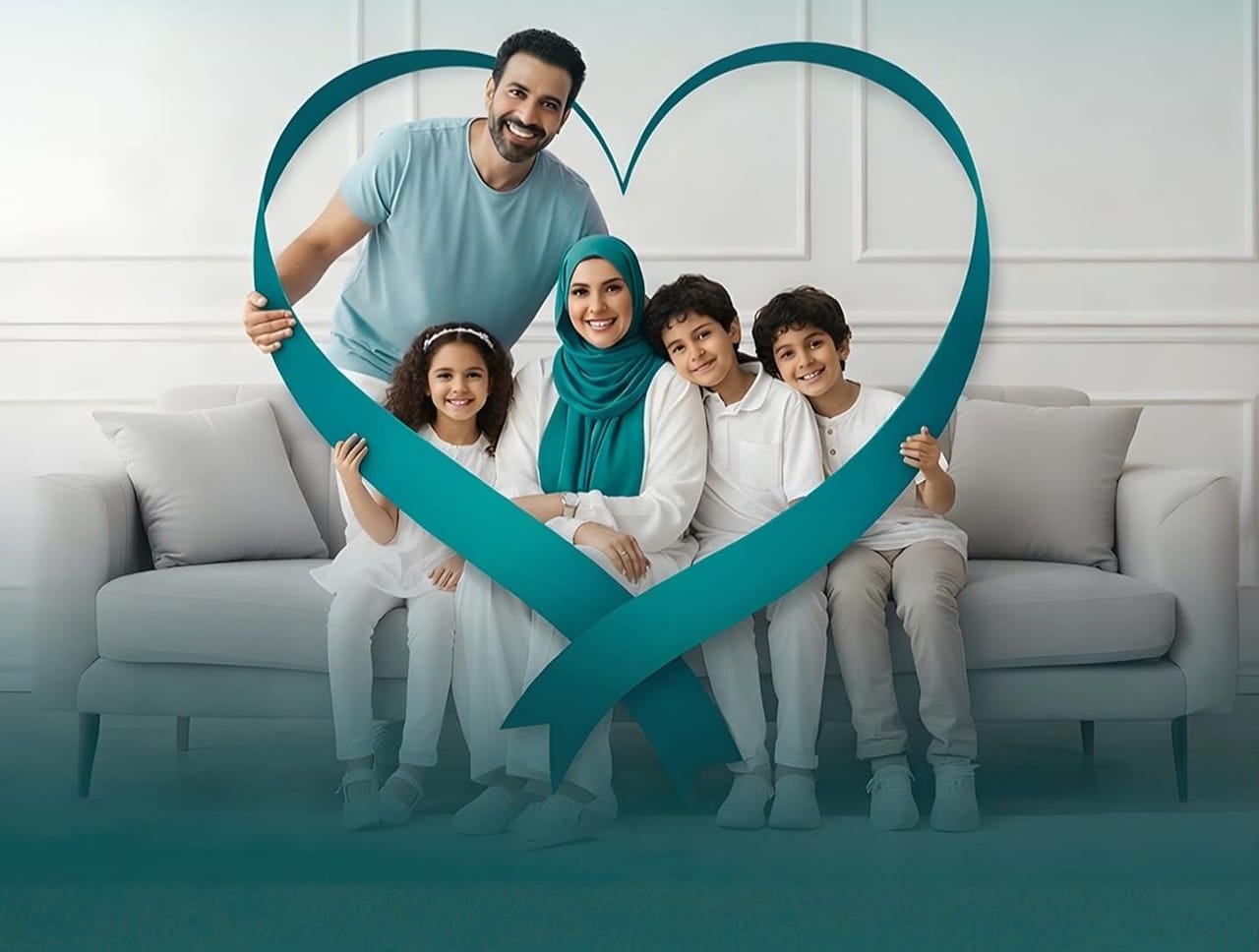 A family of five together on a sofa at home inside a teal heart-shaped ribbon